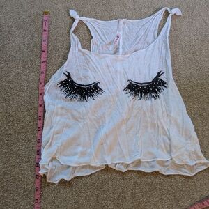 Stylish White Sleeveless Top with Black Eyelash Design
